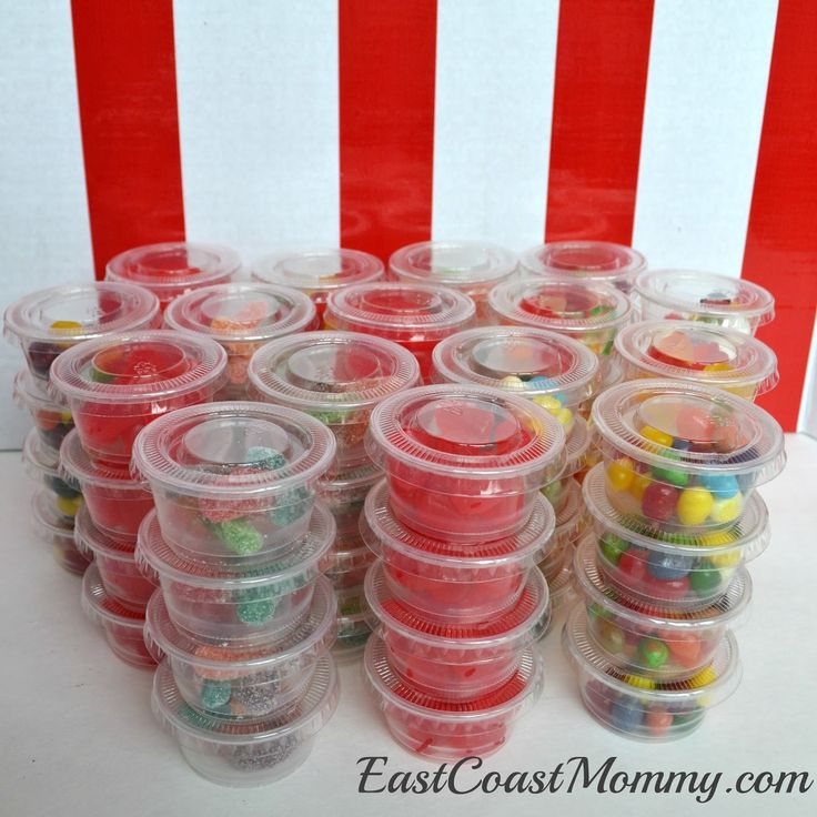 plastic containers filled with candy and candies on a table