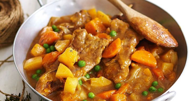 a pot filled with meat and vegetables on top of a table