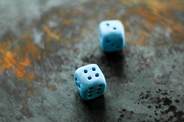 two blue dices sitting on top of a table next to each other with holes in them