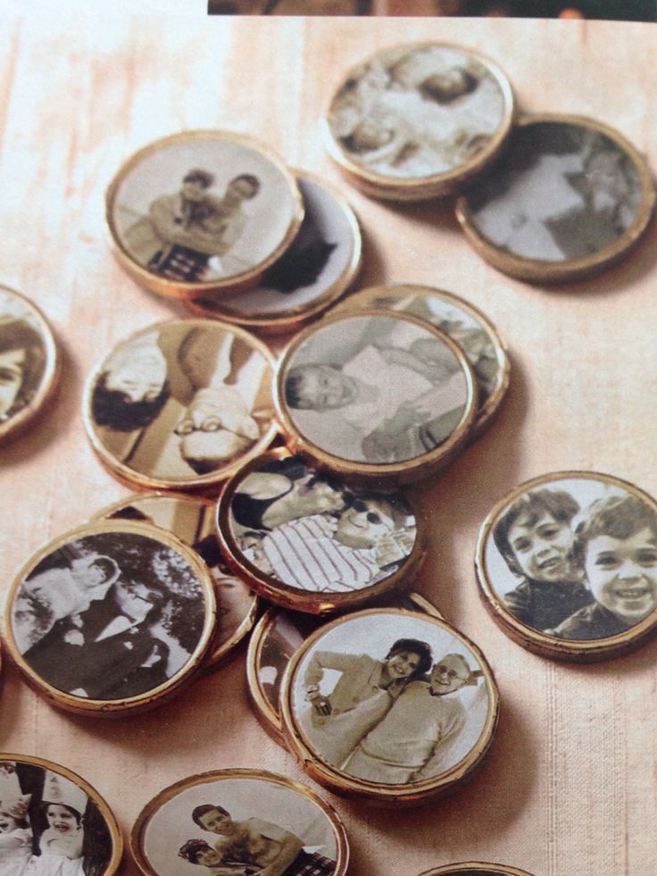 a table topped with lots of different types of pictures on top of wooden buttons and magnets