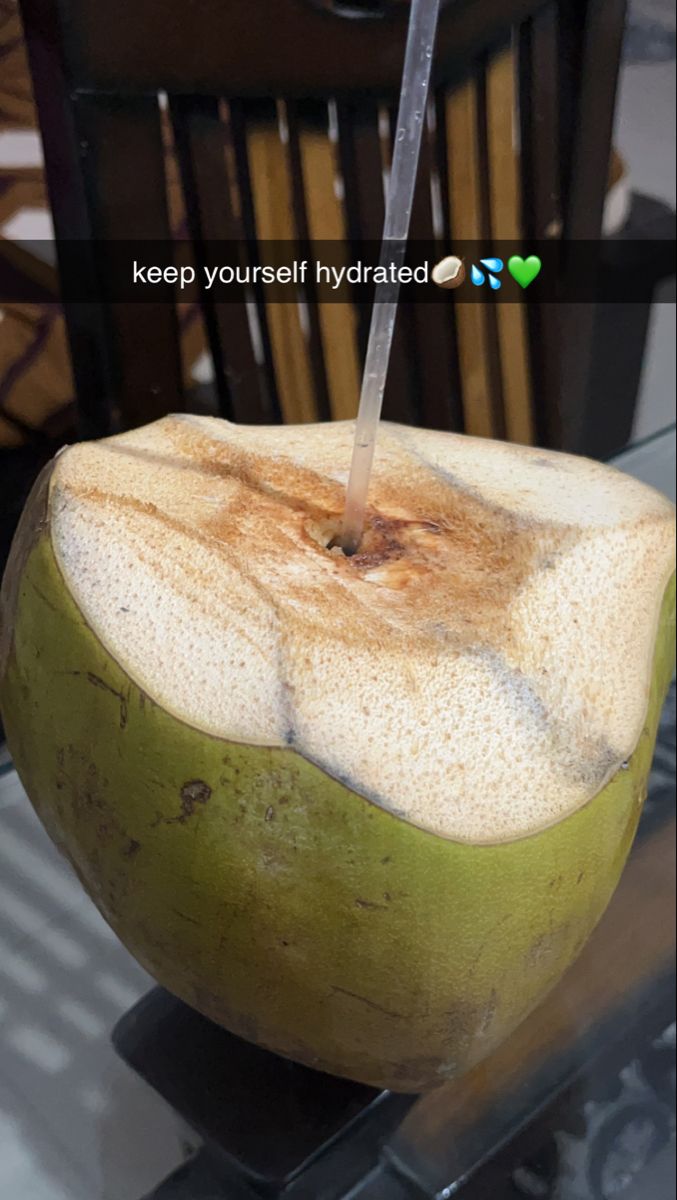 a green apple sitting on top of a glass table