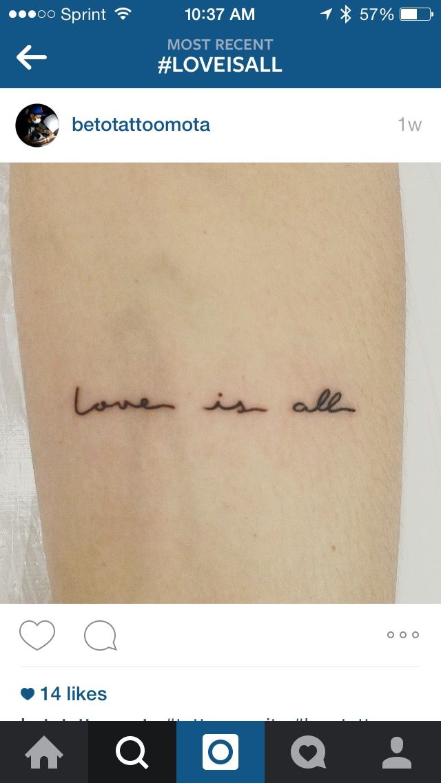 a tattoo with the words love is all around it