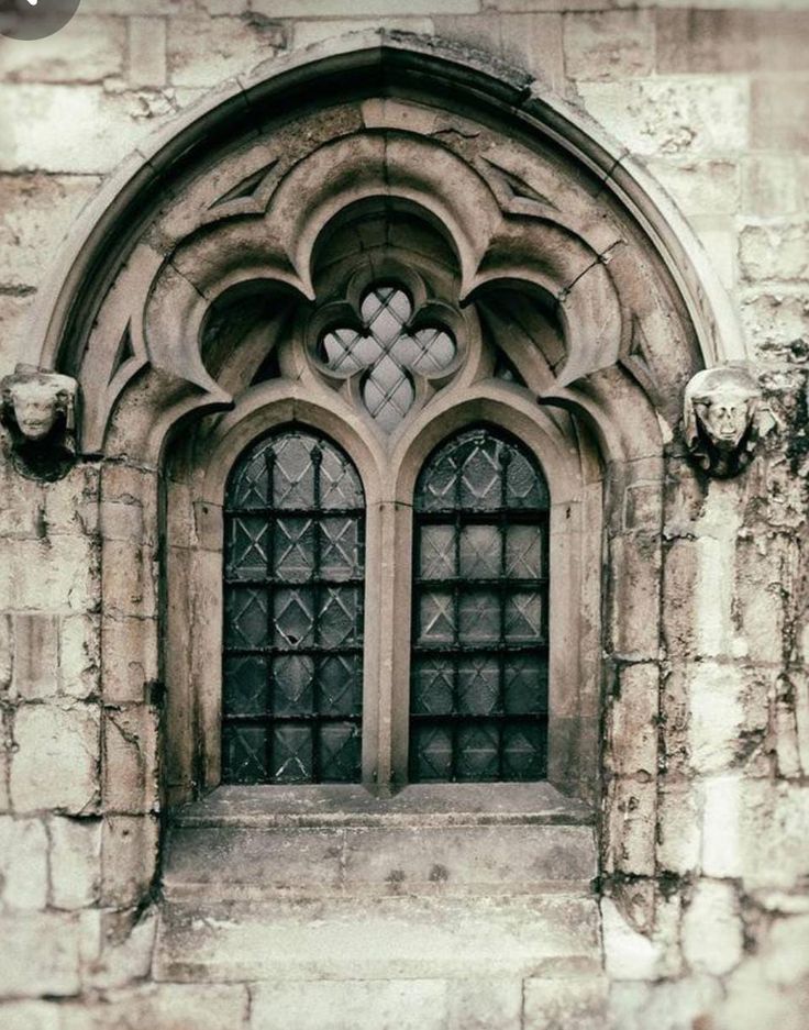 an old stone window with ornate designs on it