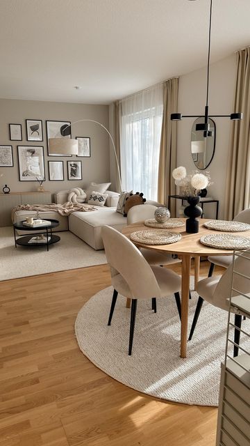 a living room filled with furniture and pictures on the wall