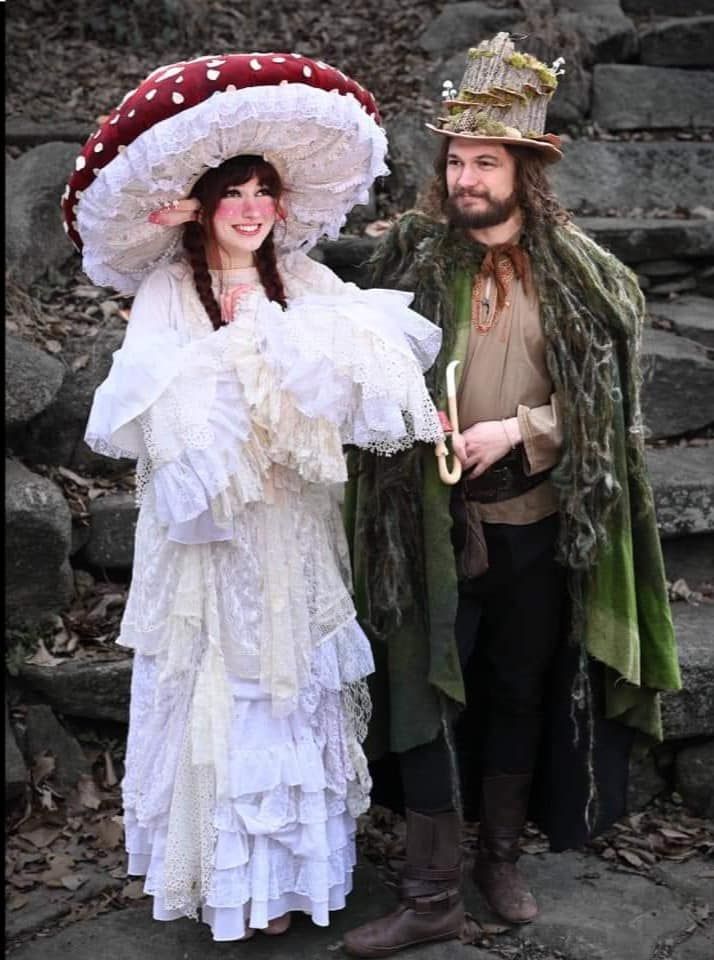 a man and woman dressed in period costumes