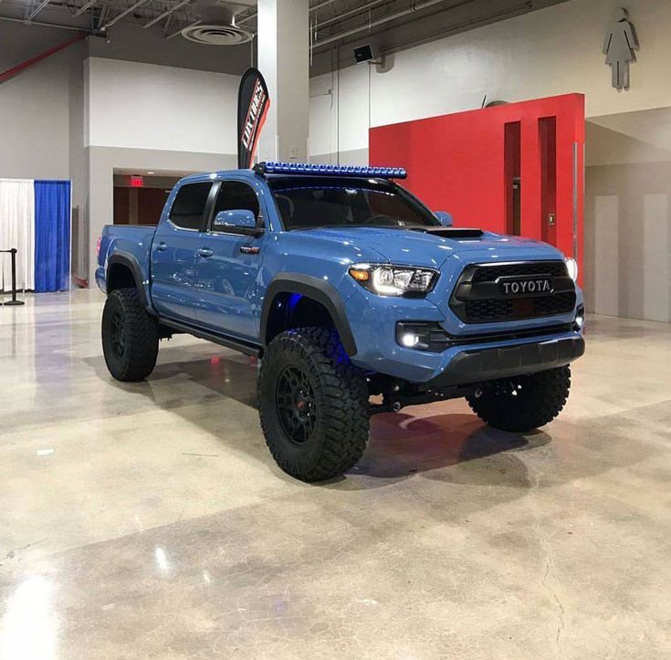 a blue toyota truck parked in a garage