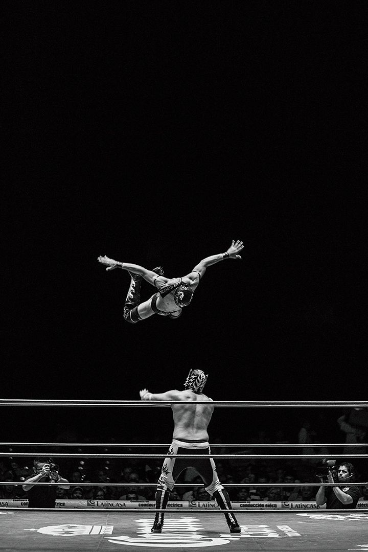 two men are performing acrobatic tricks in the ring