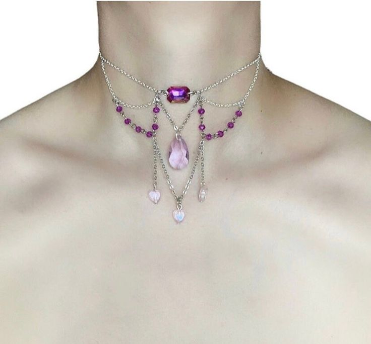 Amethyst Heart Choker 🤍 This stunning choker is made with silver chains, a purple glass connector, purple glass beads, and three pink acrylic hearts. The delicate chains and beads create a feminine and elegant look, while the pops of pink add a touch of fun and whimsy 🤍 Only one available as I like to make one of a kind pieces so that you have a unique, standout, rare, special piece that you can't find anywhere else. Keep your jewellery away from water, oils, perfumes and make sure to remove before showering and sleeping in order to keep it in it's best condition. *All intellectual property rights in our designs are and will belong to Sphider  Sphider Design Unique, Quirky, Coquette, Princesscore, Fairycore, Faecore, Romantic, Handmade  Any infringement will be pursued vigorously. Purple Beaded Chain Jewelry For Party, Purple Heart Beads Jewelry For Party, Purple Metal Clavicle Chain Necklace, Purple Party Necklace With Chain Detail, Purple Chain Necklace For Party, Pink Metal Choker For Party, Purple Party Jewelry With Adjustable Chain, Pink Heart Beads Choker Jewelry, Party Purple Clavicle Chain Necklaces