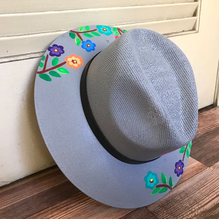 Stay stylish in this beautiful colorful hand painted straw hat, ideal for any sunny day occasion. Every single hat is hand painted uniquely which means there will never be another one like it. MADE IN MEXICO By: Mexican Artisans For: Women Size: Medium (23") Color: gray | multi Details: Material: Palm Straw Leather Band Inner elastic band Contact us for more details PLEASE READ BEFORE PURCHASE: Each product is handmade from Mexico causing differentiation and minor imperfections in each piece mak Handmade Adjustable Straw Hat For Spring, Handmade Adjustable Panama Hat For Spring, Handmade Whimsical Sun Hat For Summer, Hand Painted Brimmed Sun Hat For Spring, Hand Painted Sun Hat With Curved Brim For Spring, Hand Painted Curved Brim Sun Hat For Spring, Hand Painted Curved Brim Straw Hat For Summer, Artisan Handmade Sun Hat For Spring, Handmade Artisan Sun Hat For Spring