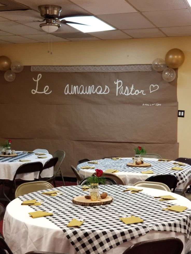 tables with black and white checkered tablecloths are set up for an event