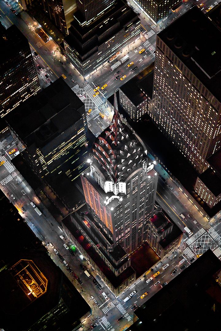 an aerial view of skyscrapers at night in new york city, from the air