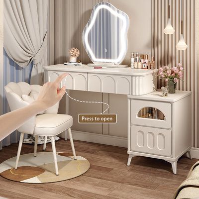 a woman is pointing at her dressing table