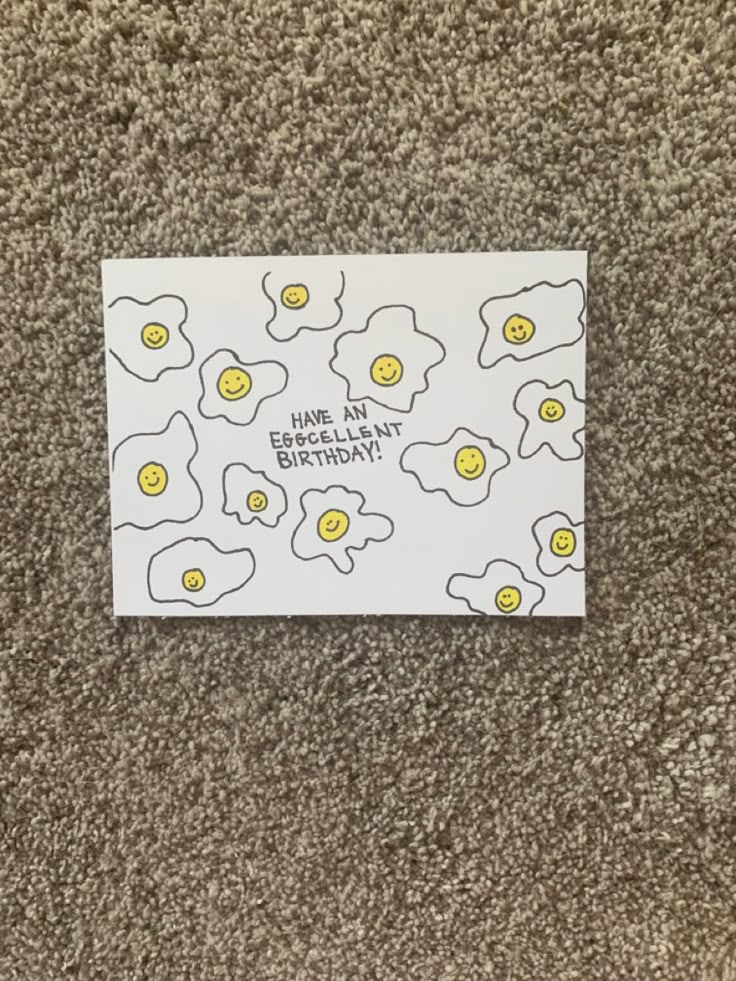 a white card with yellow eggs on it that says have an egg happy birthday?