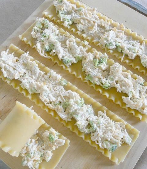 chicken alfredo lasagna roll - ups with cheese and broccoli on top