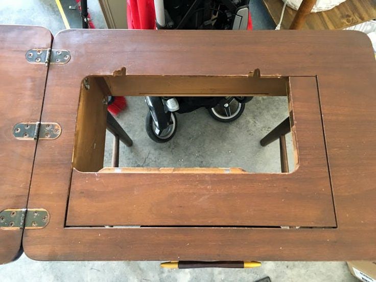 a wooden table that has been made into a coffee table with wheels on the top