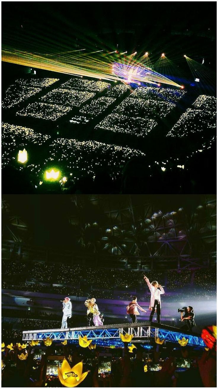 the stage is lit up with lights and people are standing on it in front of them