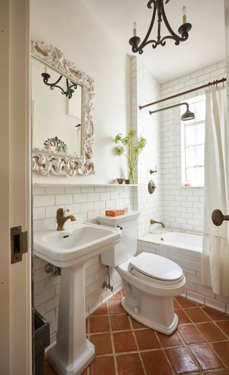 a white toilet sitting next to a bath tub under a bathroom mirror above a sink