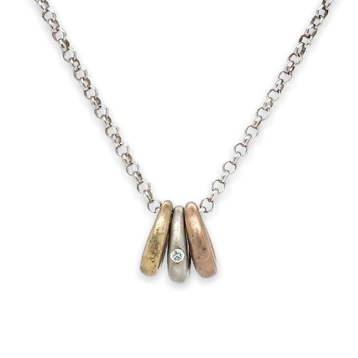 Crafted from sterling silver, this exquisite necklace features three 9.6x9.1mm satin finished ovals: one in rose gold, one in silver with a flush-set diamond, and one in yellow gold. These luxurious ovals dangle from an 18" cable chain secured with a lobster clasp, adding a total of 4dwt to the piece.Chain Type:CableClosure:LobsterColor:Silver.Main Stone:DiamondMain Stone Color:WhiteMain Stone Shape:RoundMain Stone Creation:NaturalMain Stone Treatment:UnknownSecond Stone:No StoneCustomized:NoHan Flush Set Diamond, One Rose, Link Necklace, Silver Diamonds, Tri Color, Cable Chain, Rose Gold Plates, Lobster Clasp, Stone Color