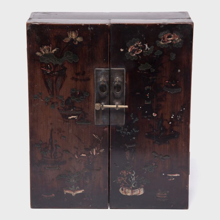 an old wooden cabinet with flowers painted on the front and side doors, one door open