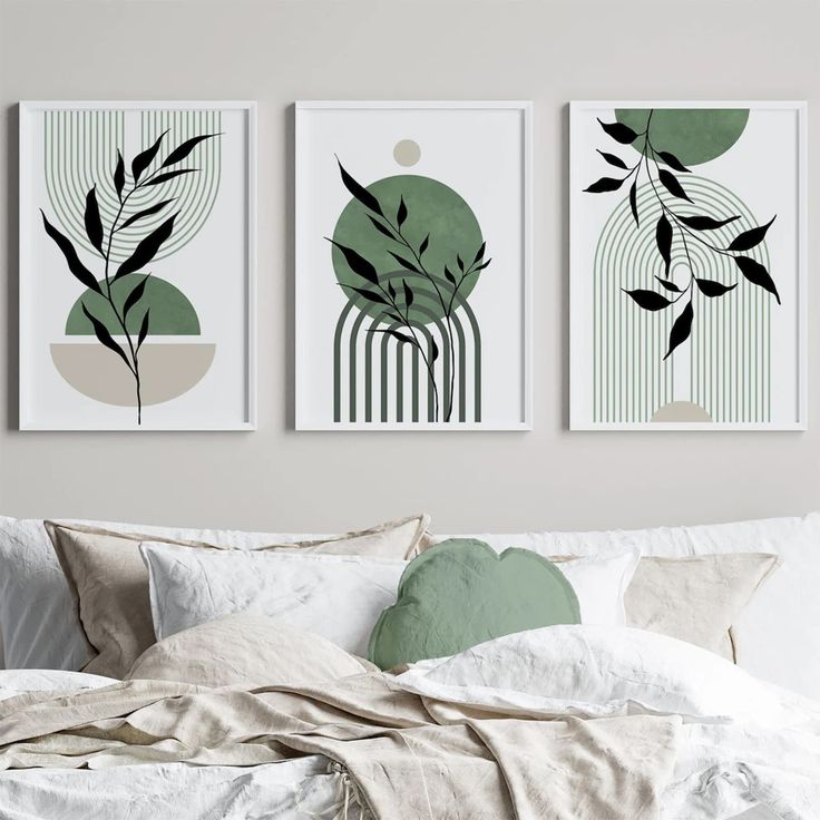 three art prints hanging on the wall above a bed