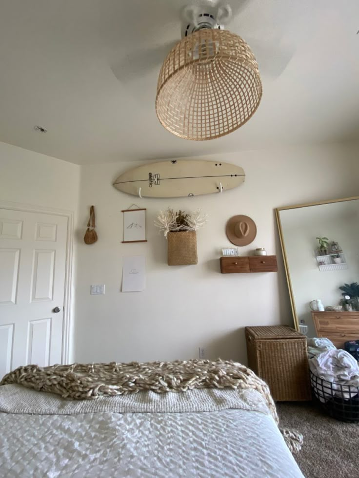 a bedroom with a surfboard hanging from the ceiling and other items on the wall