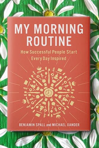 a red book sitting on top of a green and white flowered surface with the title, my morning routine how successful people start every day inspired