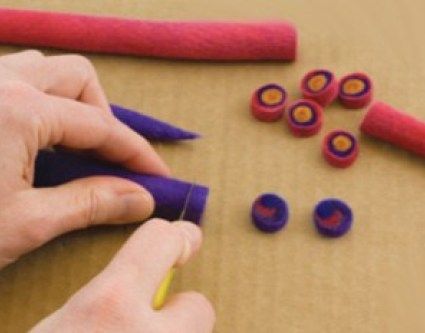 someone is making something out of felt with scissors and yarnsticks on the table