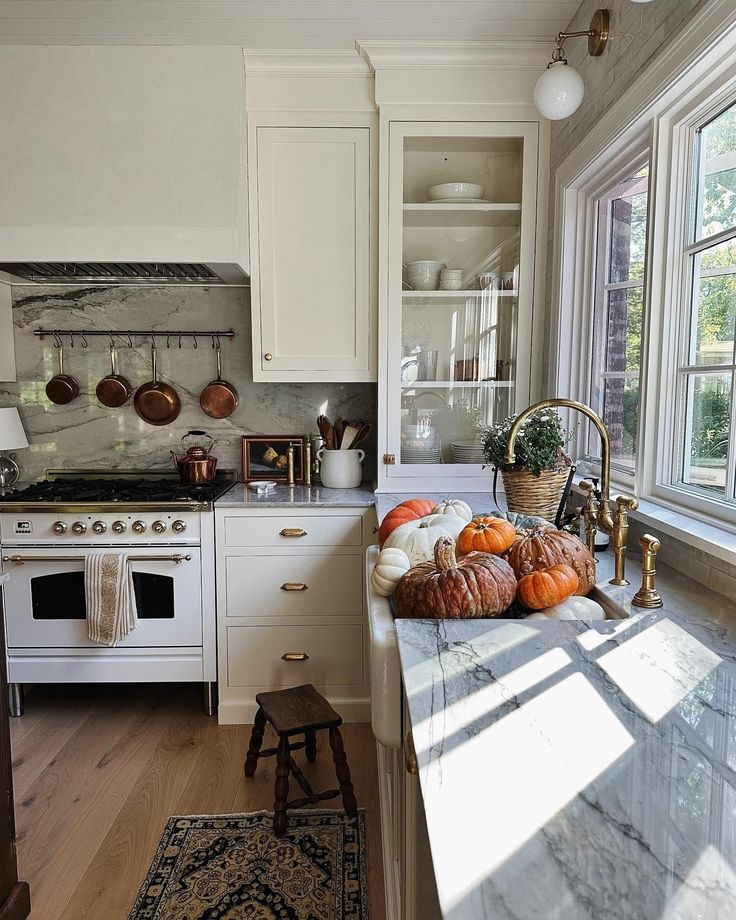 a kitchen filled with lots of counter top space next to an oven and stove top oven