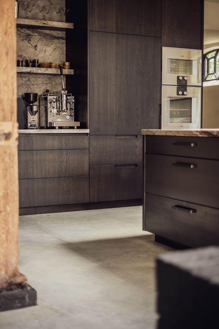 a kitchen with wooden cabinets and counter tops