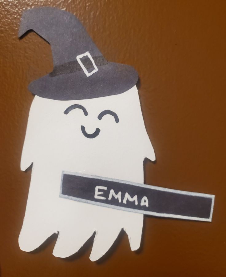 a paper cut out of a ghost with a name tag