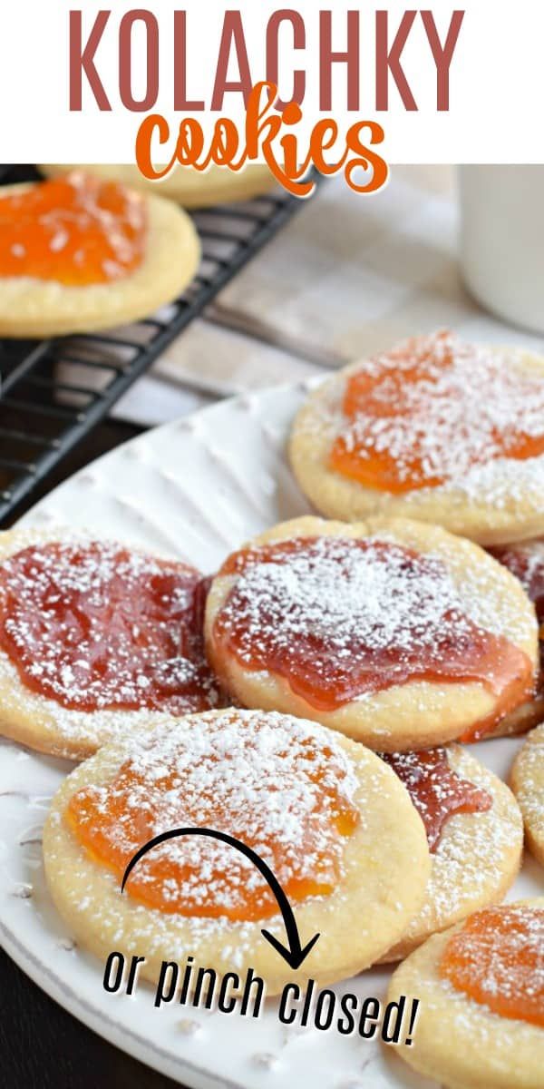 cookies with powdered sugar and jelly are on a white plate