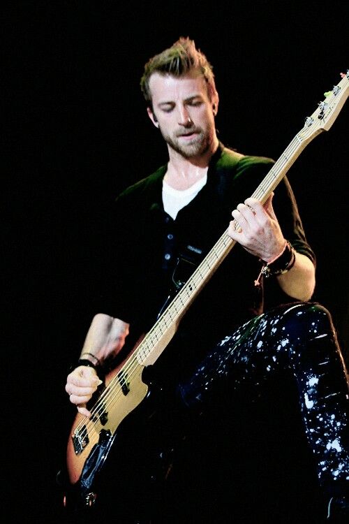 a man playing an electric guitar on stage