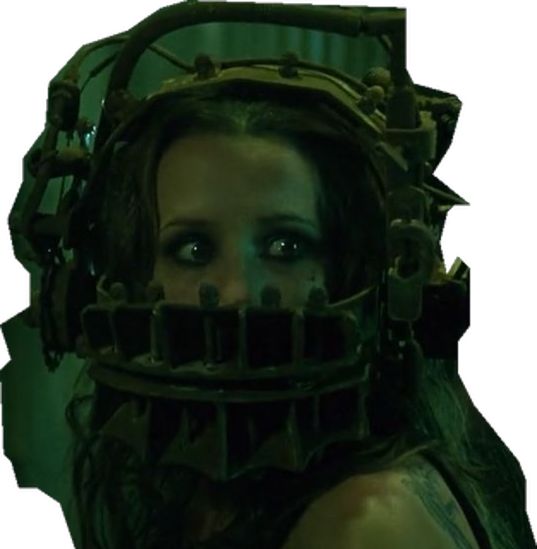 a woman with green eyes wearing a metal mask