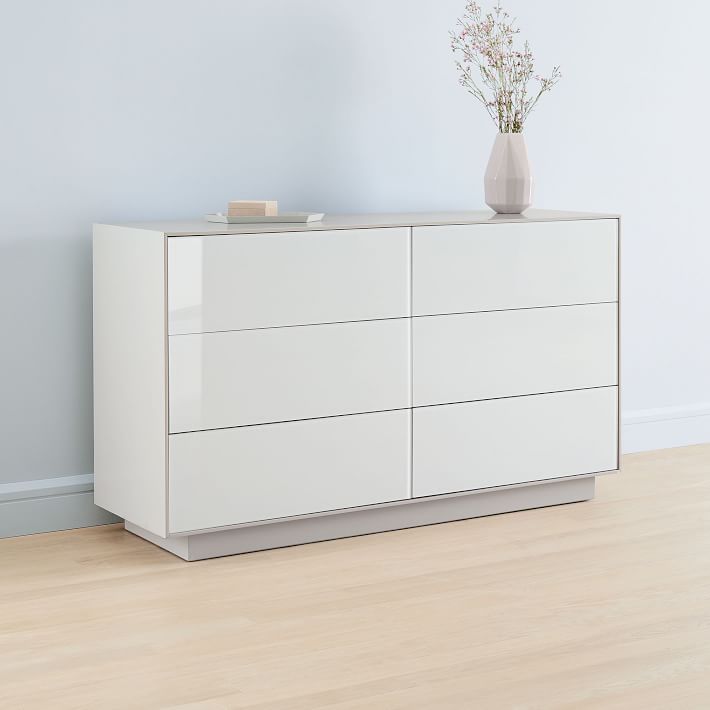 a white dresser sitting on top of a hard wood floor