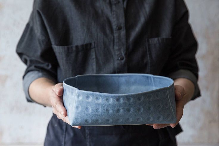 a person holding a bowl in their hands