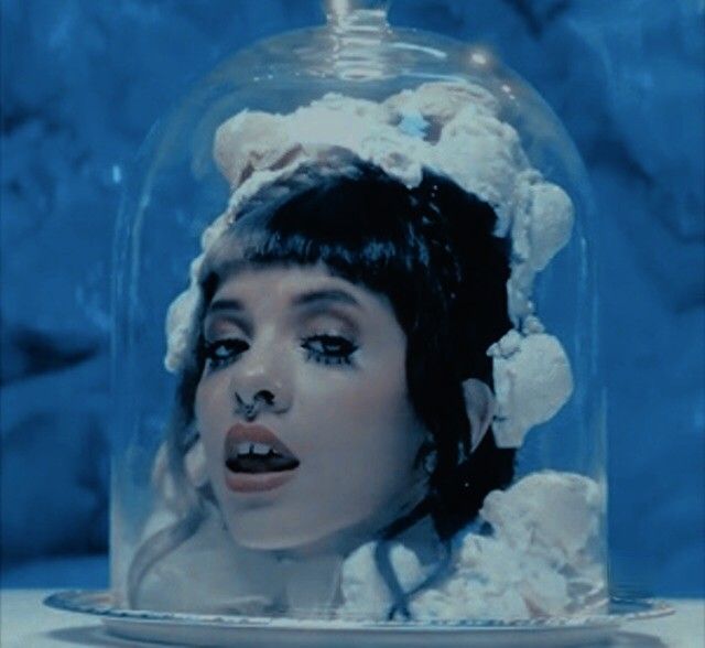 a woman with her mouth open under a glass dome