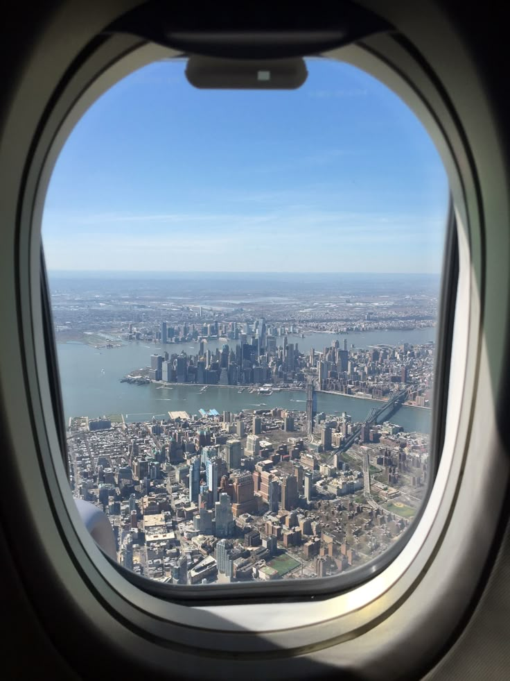 an airplane window looking out at the city