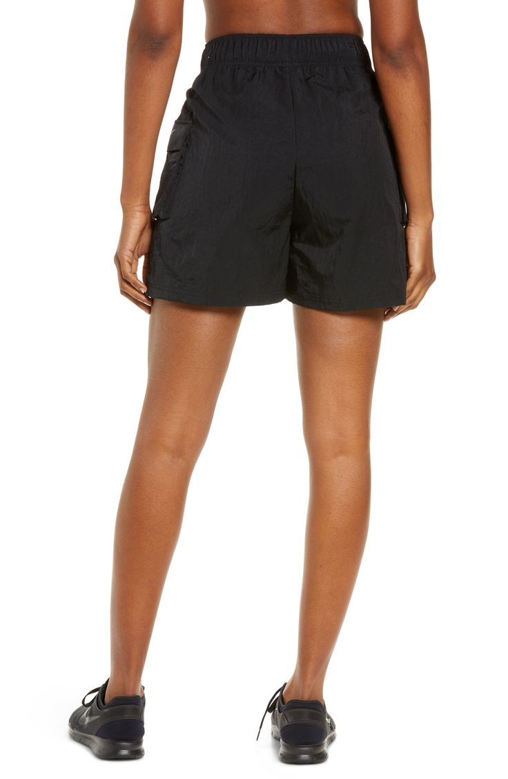 These high-waisted shorts are made from a soft, smooth woven fabric with a roomy fit, making them perfect for workouts and casual wear. Cargo pockets allow for secure storage of your small essentials. 4 1/2" inseam; 28" leg opening; 13" front rise; 17" back rise (size Medium) Drawcord-toggle waist 100% nylon Machine wash, tumble dry Imported Nike Athletic Nylon Shorts With Elastic Waistband, Nike Sporty Nylon Shorts, Nike Summer Activewear Shorts, Nike Nylon Sports Shorts, Nylon Sportswear Shorts, Sportswear Nylon Shorts, Gym Shorts With Relaxed Fit And Short Inseam, Gym Shorts Relaxed Fit, Relaxed Fit Gym Shorts With Short Inseam