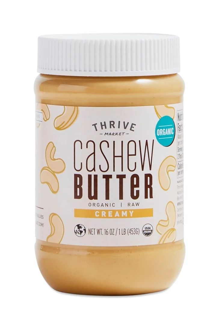 a jar of cashew butter on a white background