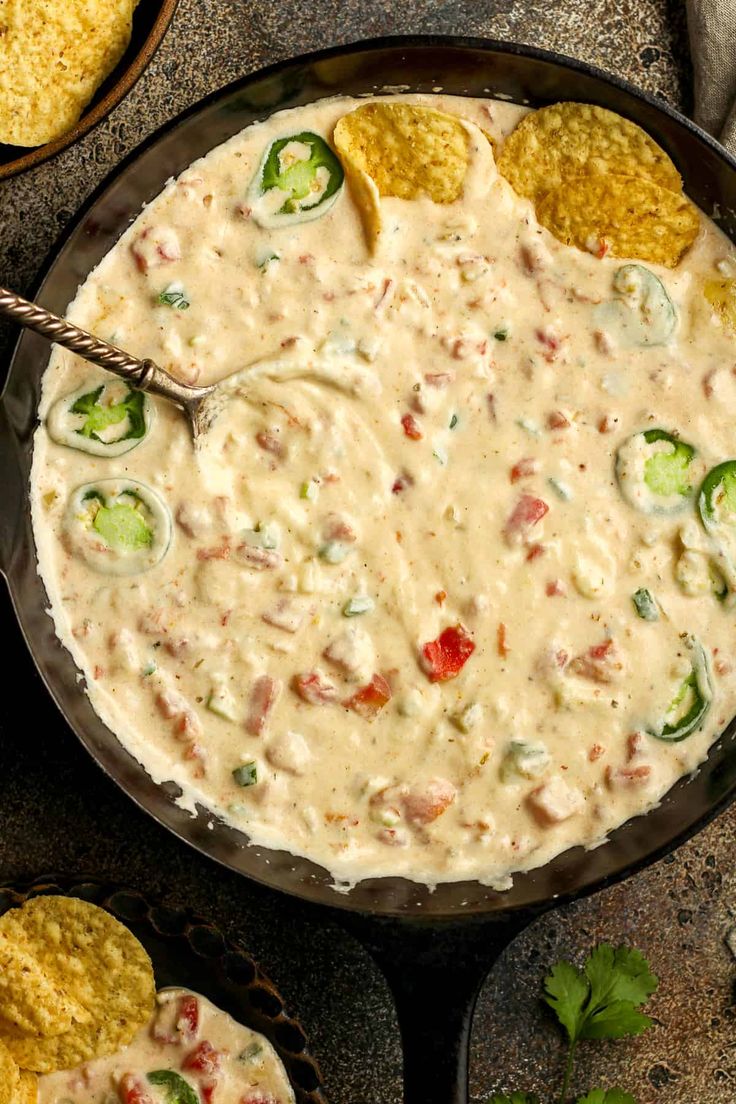 a skillet filled with quesadilla dip and tortilla chips on the side