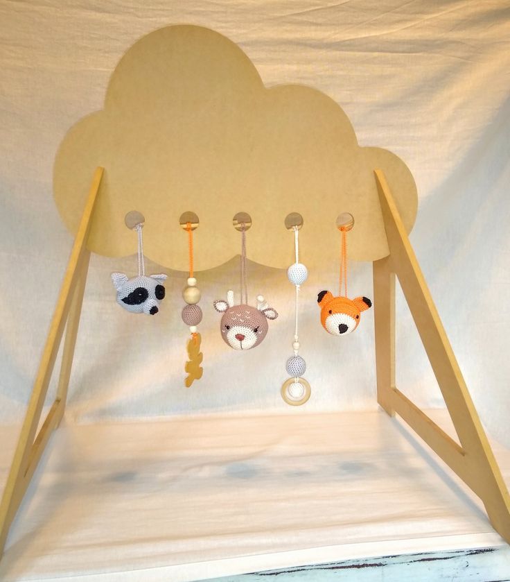 there is a baby mobile in the shape of a cloud with animals hanging from it