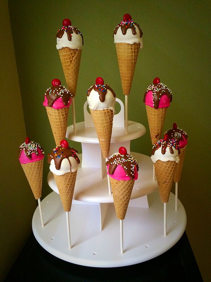 there are many ice cream cones on the cake stand