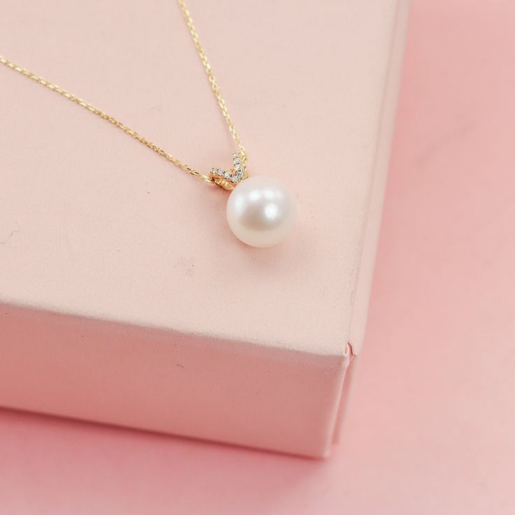 This necklace starts with a single stunning genuine freshwater pearl, which is then set into a beautiful diamond pendant, and floats on a dainty 14K solid gold chain.  The pearls are 9mm genuine, natural freshwater pearls. Made from solid 14K yellow gold (please send me a note for white or rose and allow a week for me to source the metal). These pearls are a soft rosey white. I have other pearls, too, so write me if you'd like to see something smaller, larger, or a different color.  Shop home: w Solid Gold Chains, Diamond Settings, Wedding Jewellery Necklace, Recycled Metal, Wedding Necklace, Diamond Pendant, Gold Chain, Or Rose, Gold Chains