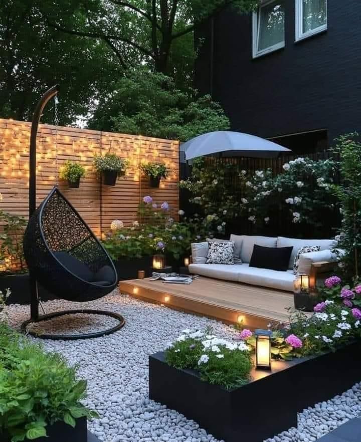 an outdoor living area is lit up with candles and lights in the middle of it