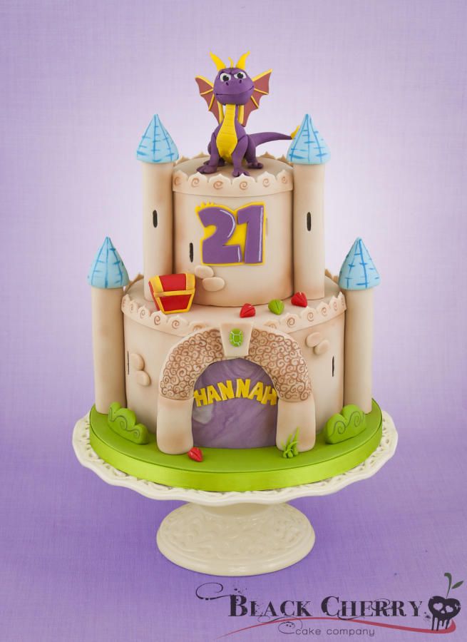 a castle cake with a purple dragon sitting on it's top and the number twenty two