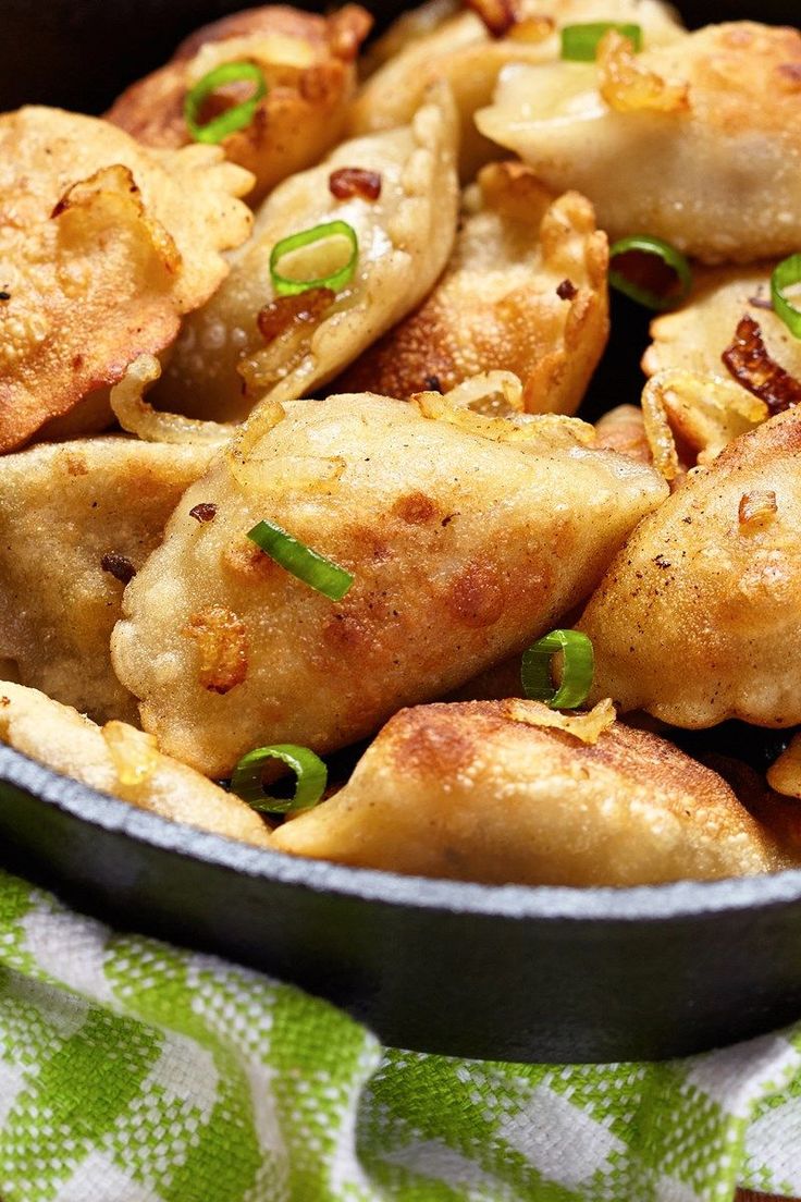 a pan filled with fried food on top of a table