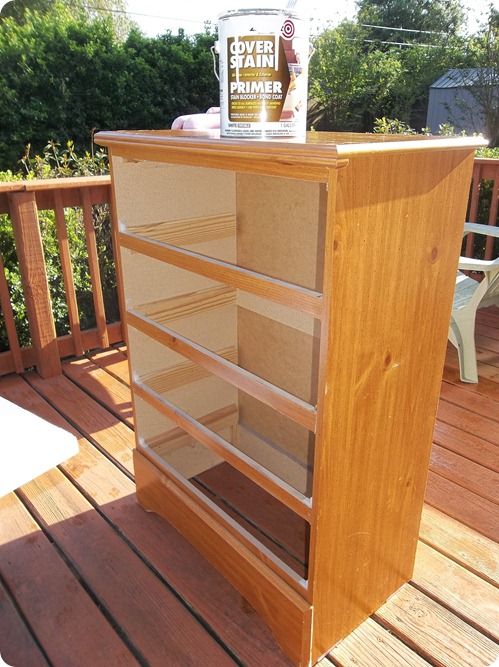 a wooden book shelf sitting on top of a deck