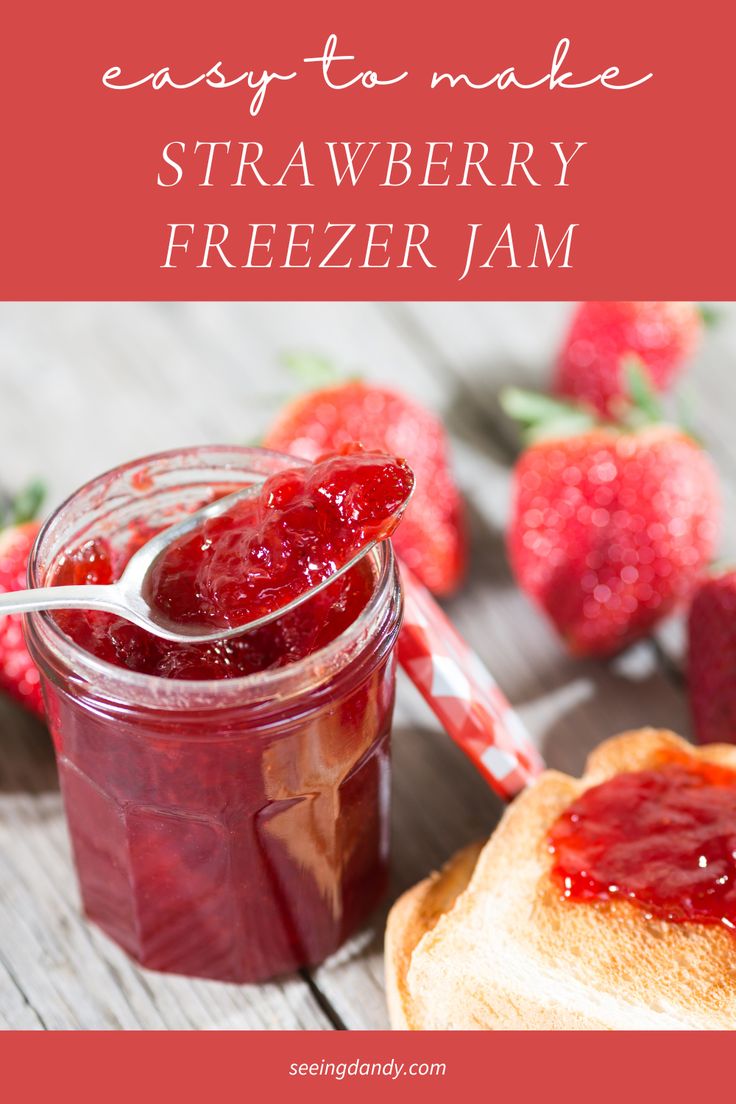 a jar of strawberry jam next to a sandwich