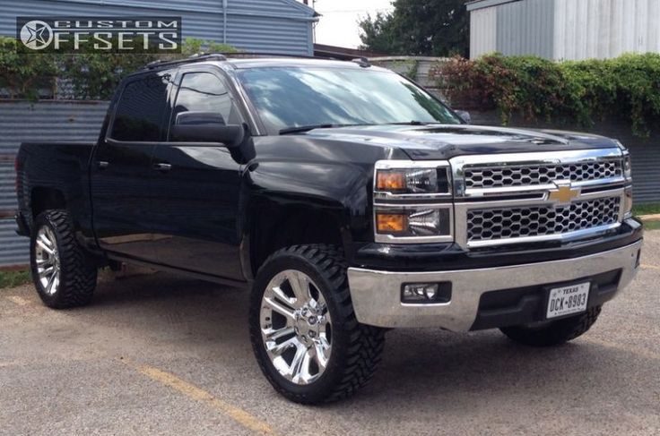 a black truck parked in front of a building