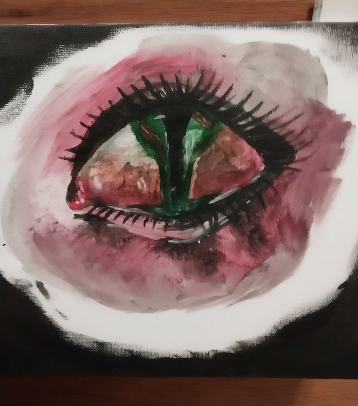 a painting of a pink and black eye with green leaves sticking out of it's center